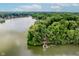 Stunning aerial shot features lakefront property with wooded acreage and private dock, perfect for nature lovers at 18 Point Ln, Arcadia, IN 46030
