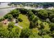 Aerial view of property showcasing extensive grounds, mature trees, and waterfront access, ideal for outdoor living at 18 Point Ln, Arcadia, IN 46030
