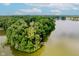 Unique lakefront property with winding steps features a private deck and lush greenery at 18 Point Ln, Arcadia, IN 46030