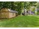 Spacious backyard with lush lawn, mature trees, and large shed at 18 Point Ln, Arcadia, IN 46030