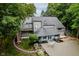 Aerial view of backyard featuring large deck, lush landscaping, and mature trees with a winding stone pathway at 18 Point Ln, Arcadia, IN 46030