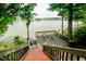 Scenic view of lake from private deck accessible by staircase, enhancing the outdoor living experience at 18 Point Ln, Arcadia, IN 46030