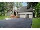 Exterior shot of home with a two-car garage and lush landscaping at 18 Point Ln, Arcadia, IN 46030