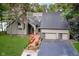 Charming home featuring an attached three-car garage, landscaped front yard, and inviting entryway with a bench at 18 Point Ln, Arcadia, IN 46030