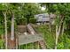 Well-maintained exterior shows outdoor living spaces featuring staircases and decks, all embraced by lush foliage at 18 Point Ln, Arcadia, IN 46030