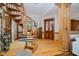 Grand foyer featuring a striking spiral staircase and hardwood floors at 18 Point Ln, Arcadia, IN 46030