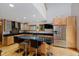 Modern kitchen with stainless steel appliances, granite countertops, an island with seating, and ample cabinet space at 18 Point Ln, Arcadia, IN 46030