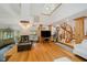 Spacious living room with hardwood floors, fireplace, and spiral staircase, creating an inviting and unique atmosphere at 18 Point Ln, Arcadia, IN 46030