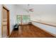 Bright living room features a ceiling fan, wood floors, and a glass door to the outside at 18 Point Ln, Arcadia, IN 46030