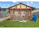 Charming backyard featuring a gazebo with seating, plants, and landscaping at 2017 E Legrande Ave, Indianapolis, IN 46203