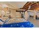Unfinished basement area with exposed ceiling, painted brick walls and bedroom area at 2017 E Legrande Ave, Indianapolis, IN 46203
