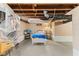 Unfinished basement with painted concrete floor, a bed, and exposed utilities at 2017 E Legrande Ave, Indianapolis, IN 46203