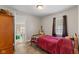 Small bedroom with single bed, guitar, and wood-look flooring at 2017 E Legrande Ave, Indianapolis, IN 46203