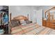 Spacious bedroom with wood accents, large bed, and dresser with mirror at 2017 E Legrande Ave, Indianapolis, IN 46203