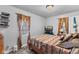 Bedroom with neutral walls, two windows, and wood-look flooring at 2017 E Legrande Ave, Indianapolis, IN 46203
