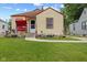 Charming bungalow with a well-maintained lawn, sidewalk and a welcoming front porch swing at 2017 E Legrande Ave, Indianapolis, IN 46203