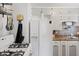 Kitchen featuring a white refrigerator, white cabinets, gas range, and stainless steel sink at 2017 E Legrande Ave, Indianapolis, IN 46203