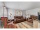 Bright living room featuring a leather sofa, striped chair, area rug, and lots of natural light at 2017 E Legrande Ave, Indianapolis, IN 46203