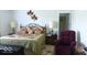 Comfortable bedroom with a queen-size bed, matching nightstands, lamps, and a cozy seating area at 204 St Andrews Ave, Edinburgh, IN 46124