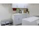 Well-equipped laundry room with ample storage cabinets and a seating bench with shoe storage space at 204 St Andrews Ave, Edinburgh, IN 46124
