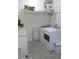 Functional laundry room with open shelving, machines, and a modern utility sink for efficient chores at 204 St Andrews Ave, Edinburgh, IN 46124