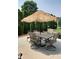 Outdoor patio featuring a cozy seating area, a unique thatched umbrella, and lush landscaping at 204 St Andrews Ave, Edinburgh, IN 46124