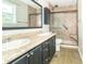 Bathroom with double vanity, framed mirror, tile shower, and neutral-toned walls at 2443 S Brandywine Ct, Greenfield, IN 46140