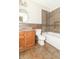 Bathroom with tiled walls, hardwood floors, white toilet, bathtub, and wood vanity at 2443 S Brandywine Ct, Greenfield, IN 46140