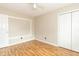 Bright bedroom with a ceiling fan, closet, neutral paint, and wood-look laminate flooring at 2443 S Brandywine Ct, Greenfield, IN 46140