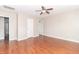 Bedroom with wood-look floors, a ceiling fan, and two doors leading to other rooms at 2443 S Brandywine Ct, Greenfield, IN 46140