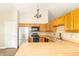 Well-lit kitchen featuring wood cabinets, stainless steel appliances, and butcher block countertops at 2443 S Brandywine Ct, Greenfield, IN 46140