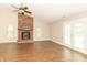 Bright living room with wood floors, brick fireplace, ceiling fan, and glass patio doors at 2443 S Brandywine Ct, Greenfield, IN 46140