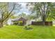 Well-maintained yard with trees, lush green grass and landscaping around the home at 2443 S Brandywine Ct, Greenfield, IN 46140