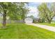 Home exterior view showing a large grassy area adjacent to the house at 2443 S Brandywine Ct, Greenfield, IN 46140