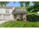 Charming two-story home features a covered front porch, stone chimney, and well-maintained landscaping at 2578 Chaseway Ct, Indianapolis, IN 46268