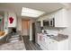 Well-lit kitchen with stainless steel appliances, a skylight, and white cabinets at 2578 Chaseway Ct, Indianapolis, IN 46268