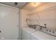 Functional laundry room features washer, dryer, and wire shelving at 2578 Chaseway Ct, Indianapolis, IN 46268