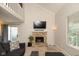 Bright living room featuring a stone fireplace, vaulted ceilings, and comfortable furnishings at 2578 Chaseway Ct, Indianapolis, IN 46268