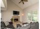 Bright living room featuring a stone fireplace, vaulted ceilings, and comfortable furnishings at 2578 Chaseway Ct, Indianapolis, IN 46268