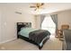 This main bedroom features a ceiling fan, large window, and a rocking chair at 2578 Chaseway Ct, Indianapolis, IN 46268