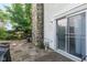 Charming patio area with stone accents, mature landscaping, and sliding glass door access at 2578 Chaseway Ct, Indianapolis, IN 46268