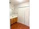 Bathroom featuring tile flooring, vanity with mirror, lights, and storage with white paneled door at 2770 Two Worlds Dr, Columbus, IN 47201