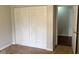 Bedroom showcasing paneled closet doors, tan carpet and entrance to another room at 2770 Two Worlds Dr, Columbus, IN 47201