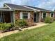 Charming brick townhome featuring a covered front porch and a well-maintained lawn at 2770 Two Worlds Dr, Columbus, IN 47201