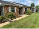 Charming brick townhome featuring a covered front porch and a well-maintained lawn at 2770 Two Worlds Dr, Columbus, IN 47201