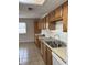 Well-lit kitchen with tile floor, wood cabinets, and double sink overlooking a window at 2770 Two Worlds Dr, Columbus, IN 47201