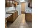 Functional kitchen featuring tile flooring, wooden cabinetry, and white appliances at 2770 Two Worlds Dr, Columbus, IN 47201