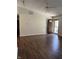Bright living room featuring wood floors, ceiling fan, and a front door letting in natural light at 2770 Two Worlds Dr, Columbus, IN 47201