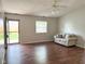 Bright living room features hardwood floors, a new sofa, and natural light from the front window at 2770 Two Worlds Dr, Columbus, IN 47201