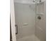 Enclosed shower unit in white featuring handheld shower head and built in shelving at 2770 Two Worlds Dr, Columbus, IN 47201
